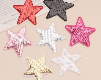May include: Six sparkly star-shaped iron-on patches in various colors, including red, pink, white, gold, silver, and black. The patches are made of sequins and are perfect for adding a touch of sparkle to clothing, bags, or other crafts.
