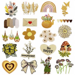 May include: A selection of embroidered patches with floral and nature-inspired designs. The patches include a rainbow, a butterfly, and a rabbit. The color palette includes yellow, brown, and beige. Some patches feature text, such as "Be Happy" and "Love yourself."