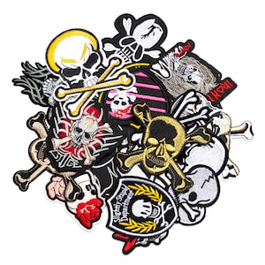 May include: A selection of embroidered patches with skull and crossbones motifs. The patches are in various colours, including black, white, gold, and red, with some incorporating additional elements like roses and text. Suitable for jackets, bags, or other fabric items.