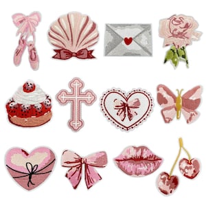 May include: A set of 12 pink and red embroidered iron-on patches featuring various designs, including a seashell, a cross, a heart, a butterfly, a cupcake, a pair of ballet shoes, a cherry, a bow, lips, and an envelope.