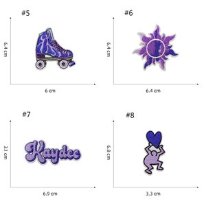 May include: Four iron-on patches with purple and white embroidery. The first patch is a purple and white roller skate. The second patch is a purple and white sun. The third patch is a purple and white word "Kaydee". The fourth patch is a purple and white stick figure holding a heart.