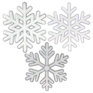 May include: Three decorative snowflake ornaments. Each snowflake is white with silver sequin detailing around the edges. The snowflakes are arranged in a triangular pattern against a white background.