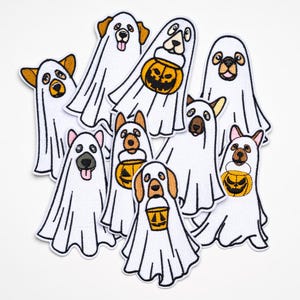 May include: A collection of embroidered patches featuring dogs dressed as ghosts for Halloween. The dogs are various breeds, with white ghost costumes and black outlines. Some hold orange jack-o'-lantern buckets.