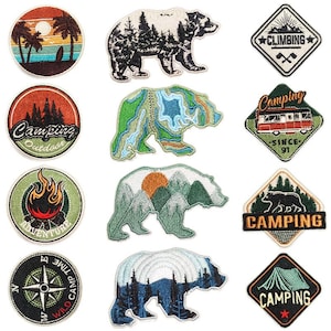 May include: Ten embroidered iron-on patches featuring a variety of camping and outdoor themes. The patches include bears, mountains, trees, a campfire, a compass, a tent, and a vintage camper van. The patches are all in different colours and styles, and they would be perfect for adding a touch of personality to your clothing, bags, or other items.