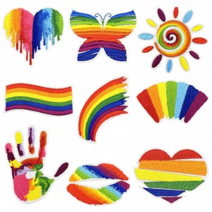 May include: Set of ten rainbow-coloured iron-on patches featuring various designs, including a heart, butterfly, sun, rainbow, handprint, lips, and a heart with stripes.