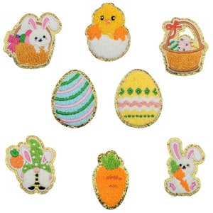 May include: Set of eight embroidered iron-on patches featuring Easter themes. The patches include a chick in an egg, a bunny in a basket, a bunny holding a carrot, a carrot, and three different Easter eggs.