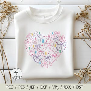 May include: White sweatshirt with a heart-shaped design made of pink, purple, blue, and yellow bows and bunnies. The text "happy easter" is written inside the heart. The sweatshirt is available in four sizes.