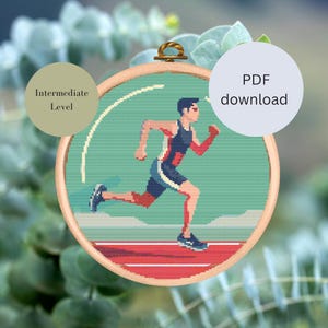 Könnte beinhalten: Kreuzstichmuster eines Läufers auf einer roten Bahn. Das Muster ist in einem runden Reifen und ist mit "Mittleres Niveau" gekennzeichnet.