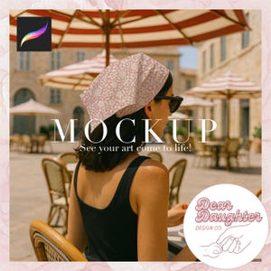 May include: A mockup image of a pink bandana with a floral pattern. The bandana is worn by a person sitting at a table outdoors. The text "MOCKUP" and "See your art come to life!" is displayed on the image. The logo "Dear Daughter Design Co." is also displayed on the image.