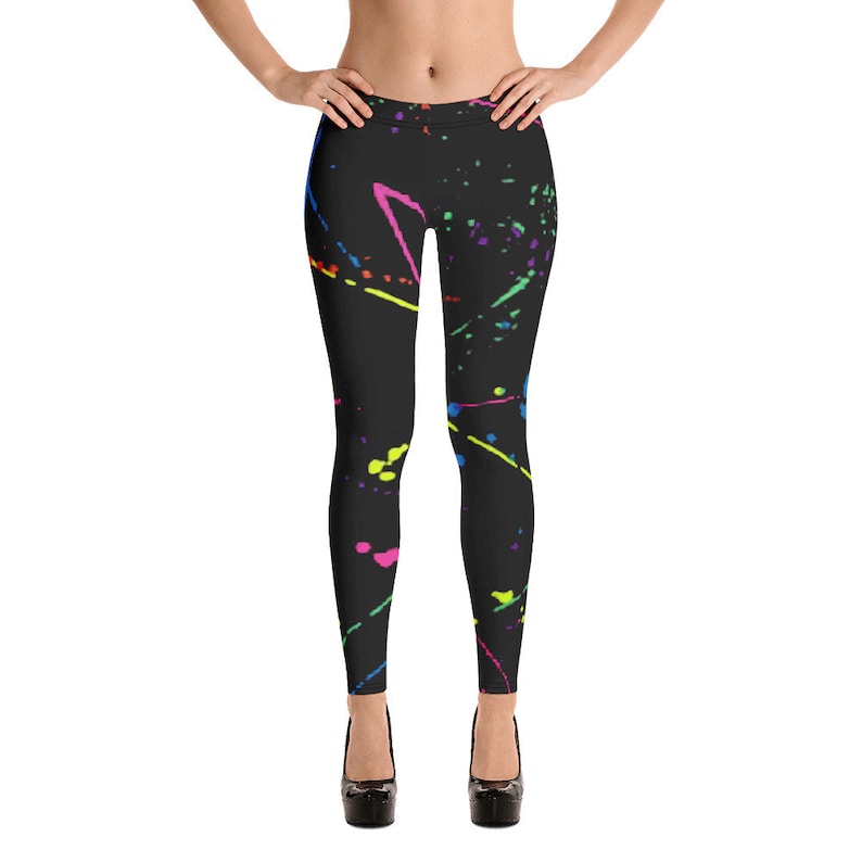 May include: Black leggings with a colorful paint splatter design. The leggings have a variety of colors including pink, blue, green, yellow, and orange.