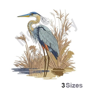 Puede incluir: Diseño bordado de una garza azul de pie en un pantano con juncos marrones y agua. La garza tiene un cuello largo, un pico largo y patas largas. El diseño es perfecto para proyectos de bordado.