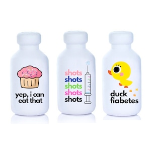 May include: Three white bottles with colorful cartoon designs and text. The first bottle has a pink cupcake with sprinkles and the text "yep, i can eat that". The second bottle has a syringe and the text "shots shots shots shots shots". The third bottle has a yellow duck and the text "duck fiabetes".