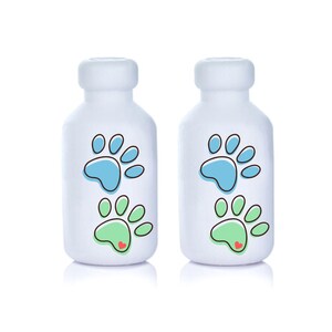 May include: Two white bottles with blue and green paw prints and a red heart. The bottles are labeled with paw prints.