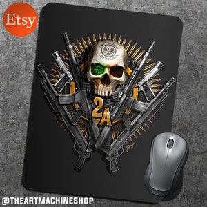 May include: A black mouse pad with a skull and crossbones design. The skull is wearing a hat with the words "Don't Tread On Me" and "Liberty or Death". The skull is surrounded by guns and bullets. The text "2A" is in the center of the design. The mouse pad is made of a durable material and is perfect for gamers and computer enthusiasts.