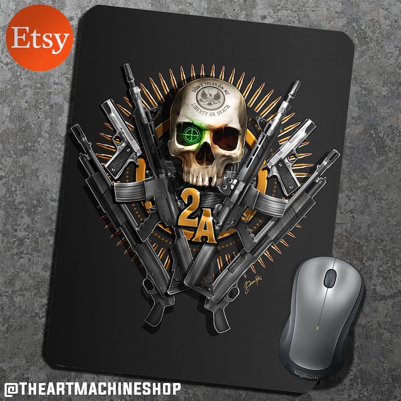 May include: A black mouse pad with a skull and crossbones design. The skull is wearing a hat with the words "Don't Tread On Me" and "Liberty or Death". The skull is surrounded by guns and bullets. The text "2A" is in the center of the design. The mouse pad is made of a durable material and is perfect for gamers and computer enthusiasts.