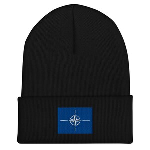 May include: Black beanie with a blue and white embroidered NATO flag patch.