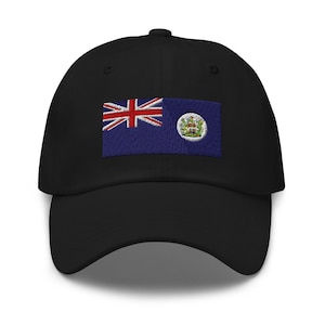 May include: Black baseball cap with an embroidered flag of the British Virgin Islands. The flag features a blue background with a white Union Jack in the upper left corner and the territory's coat of arms in the center.