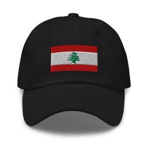 May include: A black baseball cap with an embroidered flag of Lebanon. The flag features a red, white, and green cedar tree on a white background.