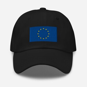 May include: A black baseball cap with an embroidered European Union flag on the front. The flag is blue with a circle of 12 yellow stars.