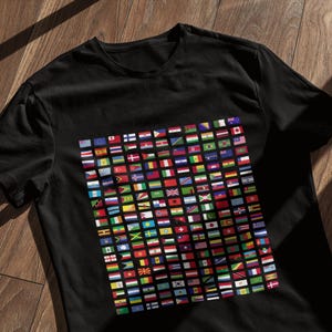 May include: A black t-shirt with a graphic print of a grid of flags from around the world.