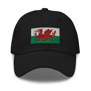 May include: Black baseball cap with an embroidered Welsh flag featuring a red dragon on a white and green background.