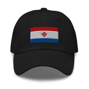 May include: A black baseball cap with an embroidered flag of the Netherlands Antilles. The flag is red, white, and blue with a red star in the center.