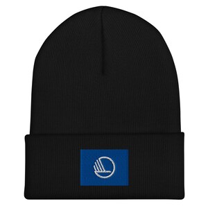 May include: Black beanie with a blue patch featuring a white stylised logo. The logo is a circle with a stylised hand inside.