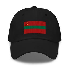 May include: Black baseball cap with an embroidered flag design. The flag features red and green horizontal stripes and a gold hammer and sickle emblem. A classic, adjustable hat.