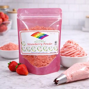 Strawberry powder used to color pink buttercream frosting with piping bag and fresh strawberries