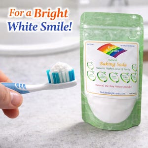 Bella Accents natural baking soda on toothbrush for teeth whitening and bright smile oral care with product pouch in background