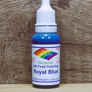 May include: A bottle of Royal Blue natural gel food coloring from Bella Accents. The bottle has a white cap and a label with a rainbow design. The liquid inside is a vibrant blue color.