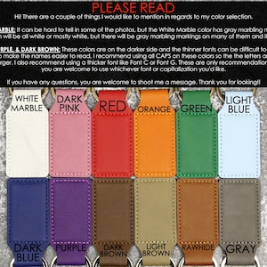 May include: A selection of leather keychains in various colors, including white marble, pink, red, orange, green, light blue, dark blue, purple, dark brown, light brown, rawhide, and gray. Each keychain has a metal ring and is labeled with its color.