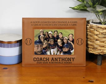 May include: A brown leather picture frame with a team photo. The frame has the text "A GOOD COACH CAN CHANGE A GAME. A GREAT COACH CAN CHANGE A LIFE." and "COACH ANTHONY 2025-2026 AUBURNDALE HEROES."