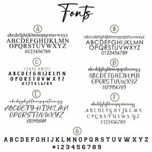 May include: A white background displays the word "Fonts" in a cursive script. Below, seven font styles are presented, each with lowercase and uppercase alphabets, and numbers. Font styles vary from classic to handwritten.