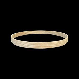 May include: A circular wooden embroidery hoop, pale in colour, set against a black backdrop. The hoop is constructed from layered wood, presenting a smooth, natural finish. It's designed to hold fabric taut for embroidery or other crafts, with a diameter of approximately 20 cm.