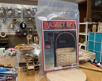 May include: A basket weaving kit with a red and white label that says "Basket Kit Beginner Basket". The kit includes a wooden base and instructions for making a basket. The finished size of the basket is 7" x 7" x 5".