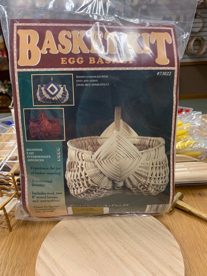 May include: A basket weaving kit for an egg basket. The kit includes reed, two 8-inch round hoops, and instructions. The finished basket is 6 inches tall, 9 inches wide, and 8 inches deep. The kit is shown with the basket enhanced with dyes and stains, which are available separately.