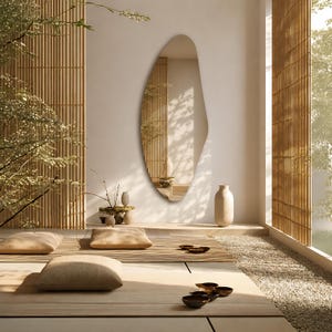 Large frameless geometric organic wall mirror featuring a tall sculptural silhouette with softly faceted contours and polished edges. Crafted from premium-quality mirror glass, it delivers a bright, natural reflection while adding artistic depth and visual interest to any space. Ideal for entryways, living rooms, bedrooms, dressing areas, and hallways. Its distinctive contemporary design complements modern, minimalist, Scandinavian, Japandi, and luxury interiors.