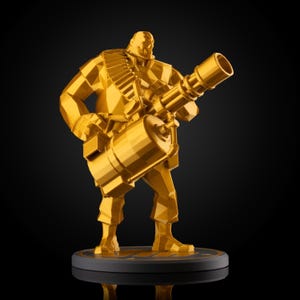 May include: A gold-colored figurine of a soldier holding a large machine gun. The figure is standing on a black base. The figurine has a geometric, polygonal design.