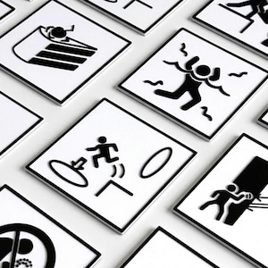 May include: A white ceramic mug with a black handle and the text "But First, Coffee" in a bold, black font. The mug is set against a blurred background, suggesting a cozy setting.