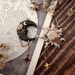 fairycore, pastel goth, mushroom decor, nature inspired, boho charm, celestial vibes, magical creature, herbology, enchanted forest, moonchild, spiritual gift, witchy aesthetic, moon phases, cottage witch, dreamy charm, rustic jewelry, terrarium style, fantasy charm, garden witch, starry night, luna moth, folk art jewelry, springtime vibes, tiny treasures, cozy decor, handmade aesthetic, fae realm, mystical charm, woodland magic, celestial gift, dark cottagecore witch Sun and Moon