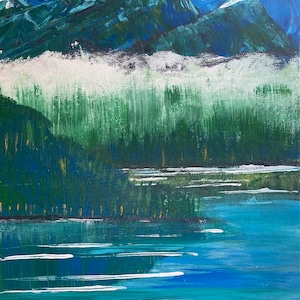 May include: An acrylic painting depicts a mountain landscape with a lake. The artwork features blue skies, snow-capped mountains, and a forest reflected in the water. The color palette includes shades of blue, green, and white, creating a serene and natural scene.