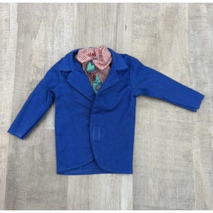 May include: A blue blazer with a red and white striped shirt and a patterned tie. The blazer has long sleeves and a notched collar. The shirt has a red and white striped pattern. The tie has a floral pattern.