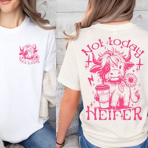May include: Two white t-shirts with a pink graphic of a Highland cow. The front shirt has the text "Not today" and the back shirt has the text "Not today HEIFER".