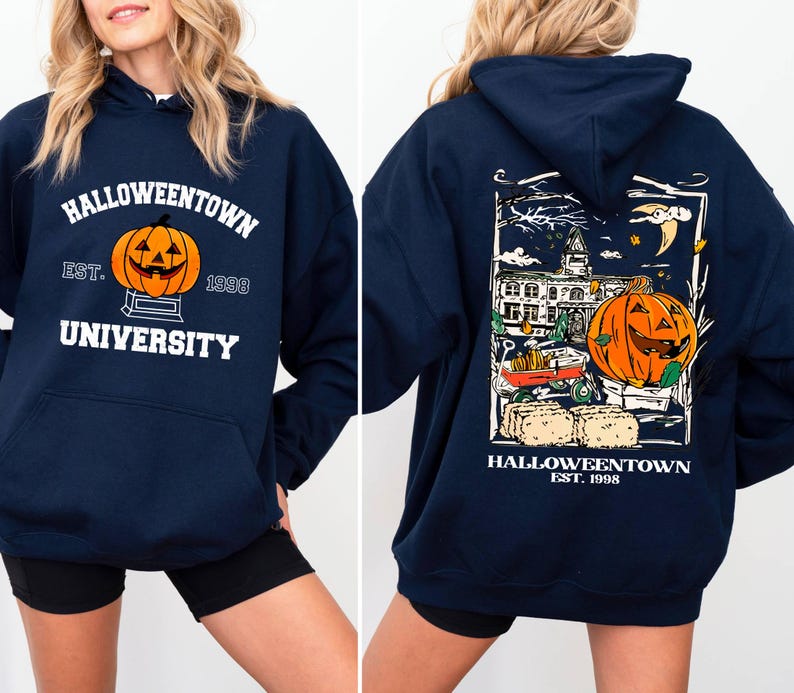 May include: Navy blue hooded sweatshirt with "Halloweentown University" and a jack-o'-lantern graphic on the front. The back features a Halloween-themed illustration with a pumpkin, buildings, and the text "Halloweentown Est. 1998."