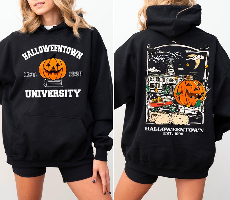 May include: Black hooded sweatshirt with a Halloween theme. The front features a jack-o'-lantern and the text "Halloweentown University Est. 1998." The back displays a detailed graphic of a pumpkin, buildings, and the text "Halloweentown Est. 1998."