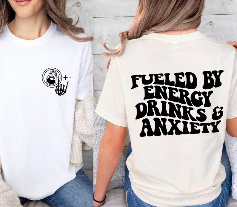 May include: Two white t-shirts with black text and graphics. The front shirt has a skeleton hand holding a can of energy drink. The back shirt says "Fueled by Energy Drinks & Anxiety".