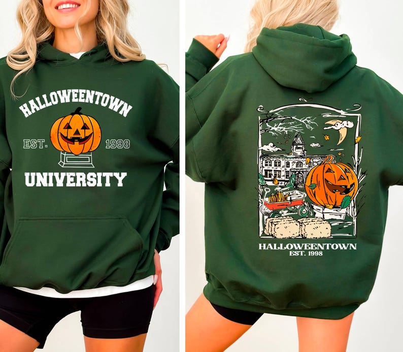 May include: Dark green Halloween-themed hoodie with a front graphic of a jack-o'-lantern and the text "Halloweentown University Est. 1998." The back features a detailed illustration of a pumpkin, a building, and the text "Halloweentown Est. 1998."