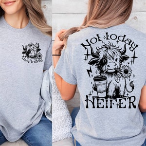 May include: Gray t-shirt with a black and white cartoon cow holding a coffee cup and a sunflower. The text "Not today, Heifer" is printed on the back of the shirt.