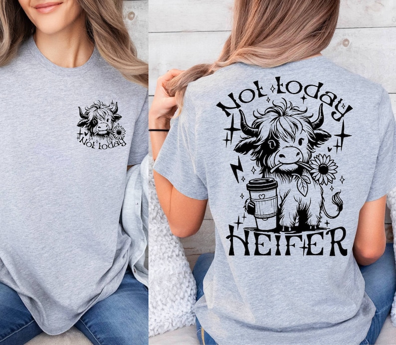 May include: Gray t-shirt with a black and white cartoon cow holding a coffee cup and a sunflower. The text "Not today, Heifer" is printed on the back of the shirt.